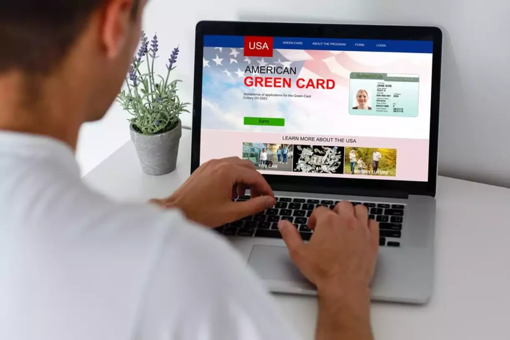 Person looking at green card information on a laptop