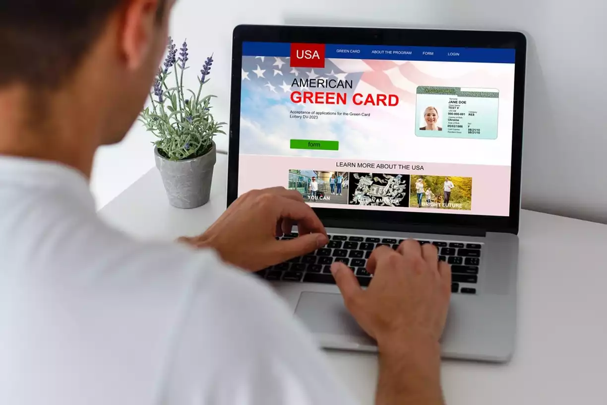 Person looking at green card information on a laptop