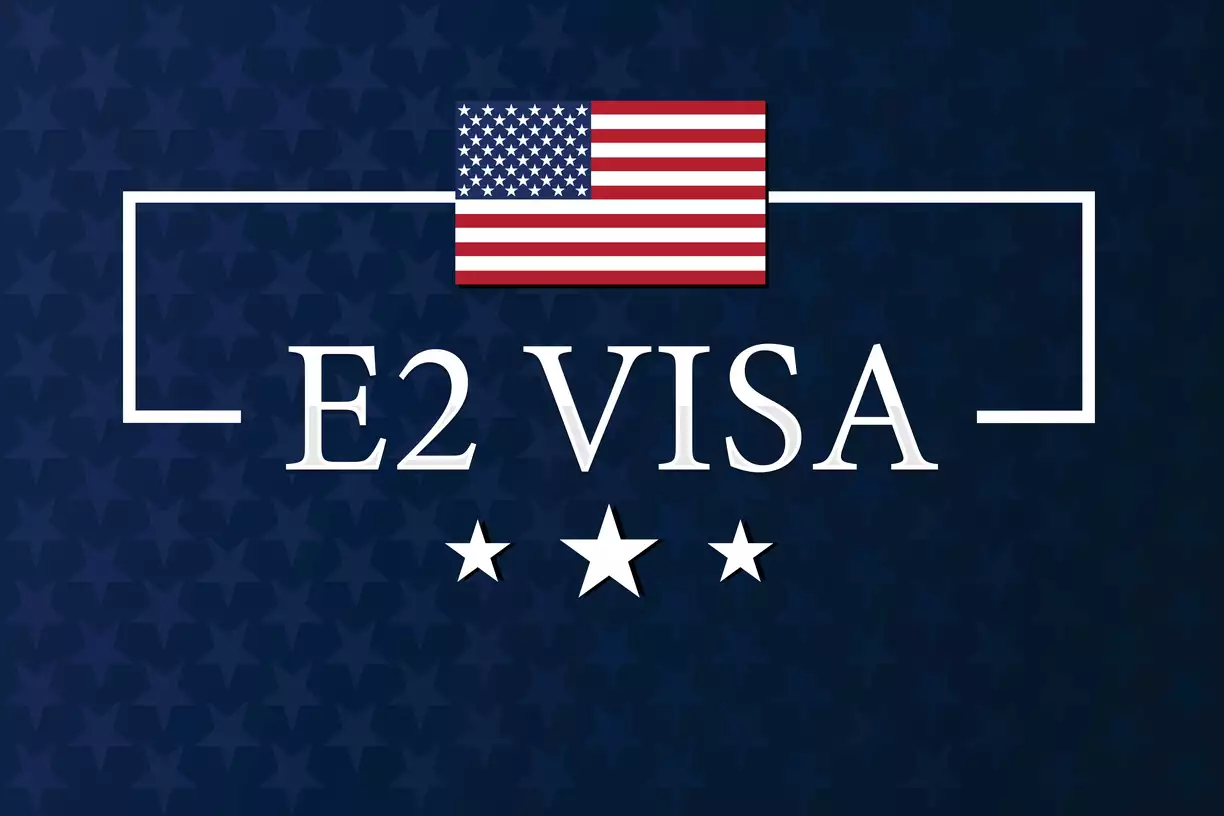 E2 visa on blue background with American flag above