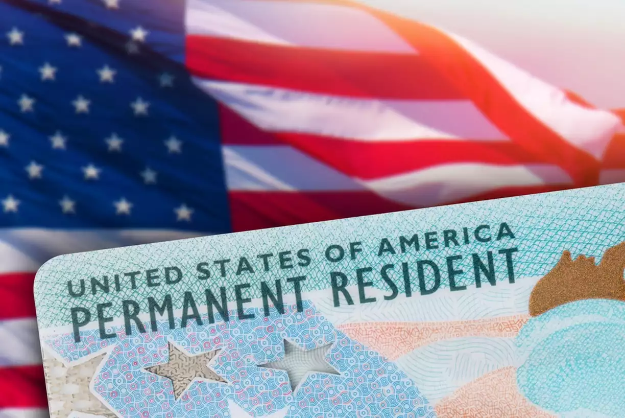 Green Card US Permanent resident card. American flag on background