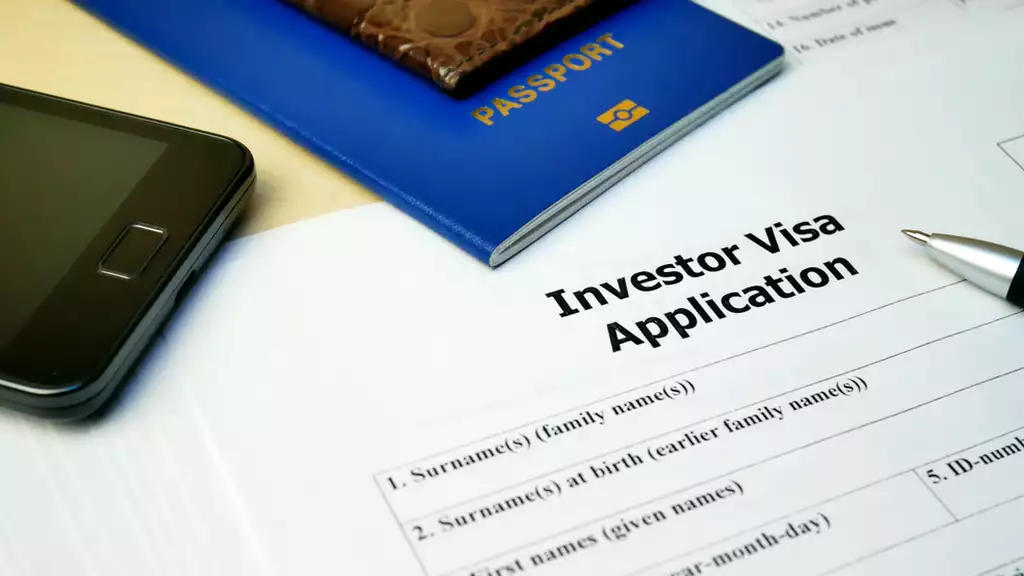 Investor visa application with passport sitting on top